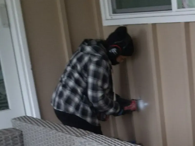 Professional electrician installing an exterior outlet in Green